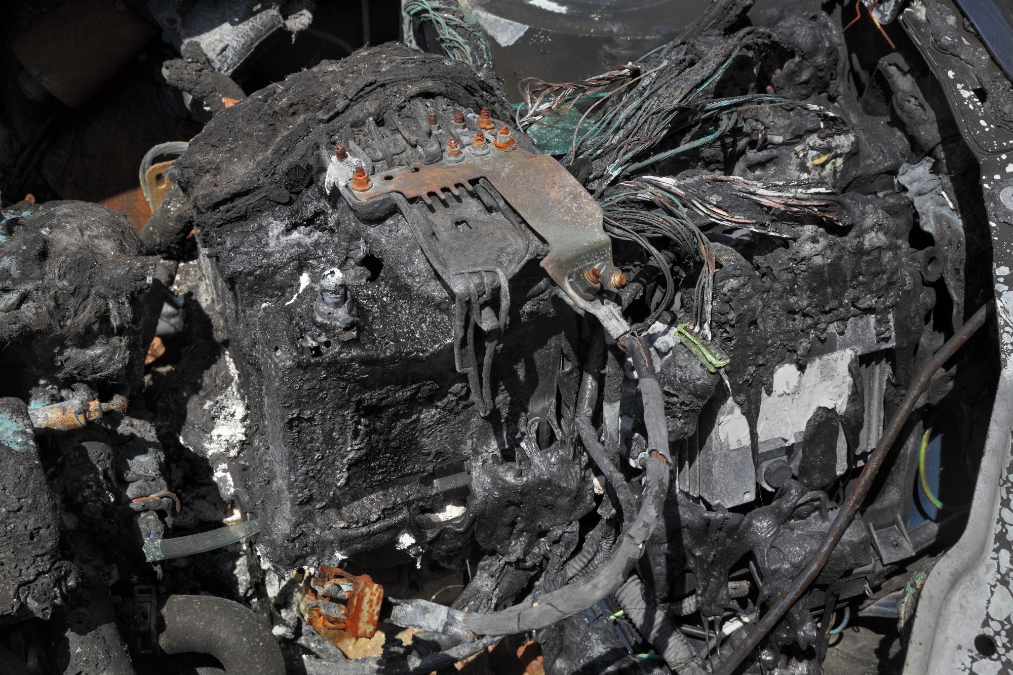 Burned and damaged car battery after fire accident