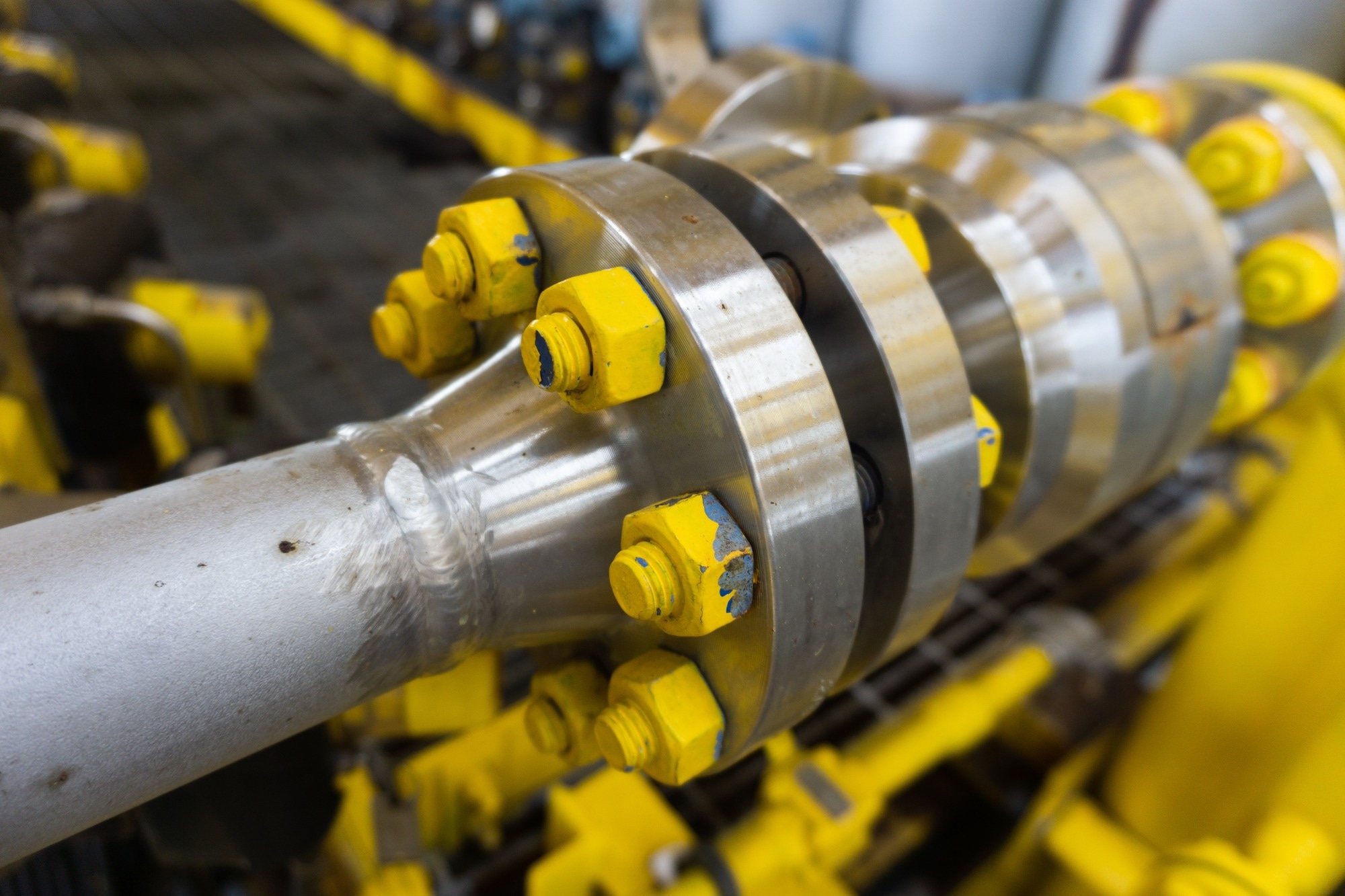 Installation of duplex pipes and flanges with carbon nut painted over with rust paint for use in offshore gas transportation.