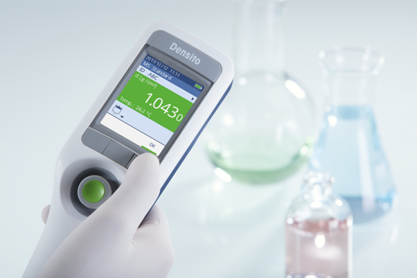 Densito product image. User holds tool in one hand.