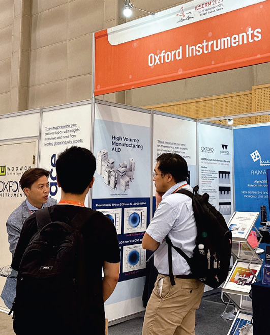 Images from ICSCRM 2025 in Busan, South Korea. Three men speak in front of the Oxford Instruments stand.