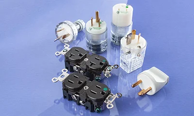 A photo of a range of different plugs against a purple background.