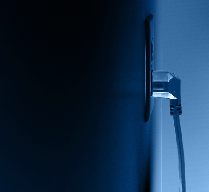 An image of a plug being plugged into a wall.