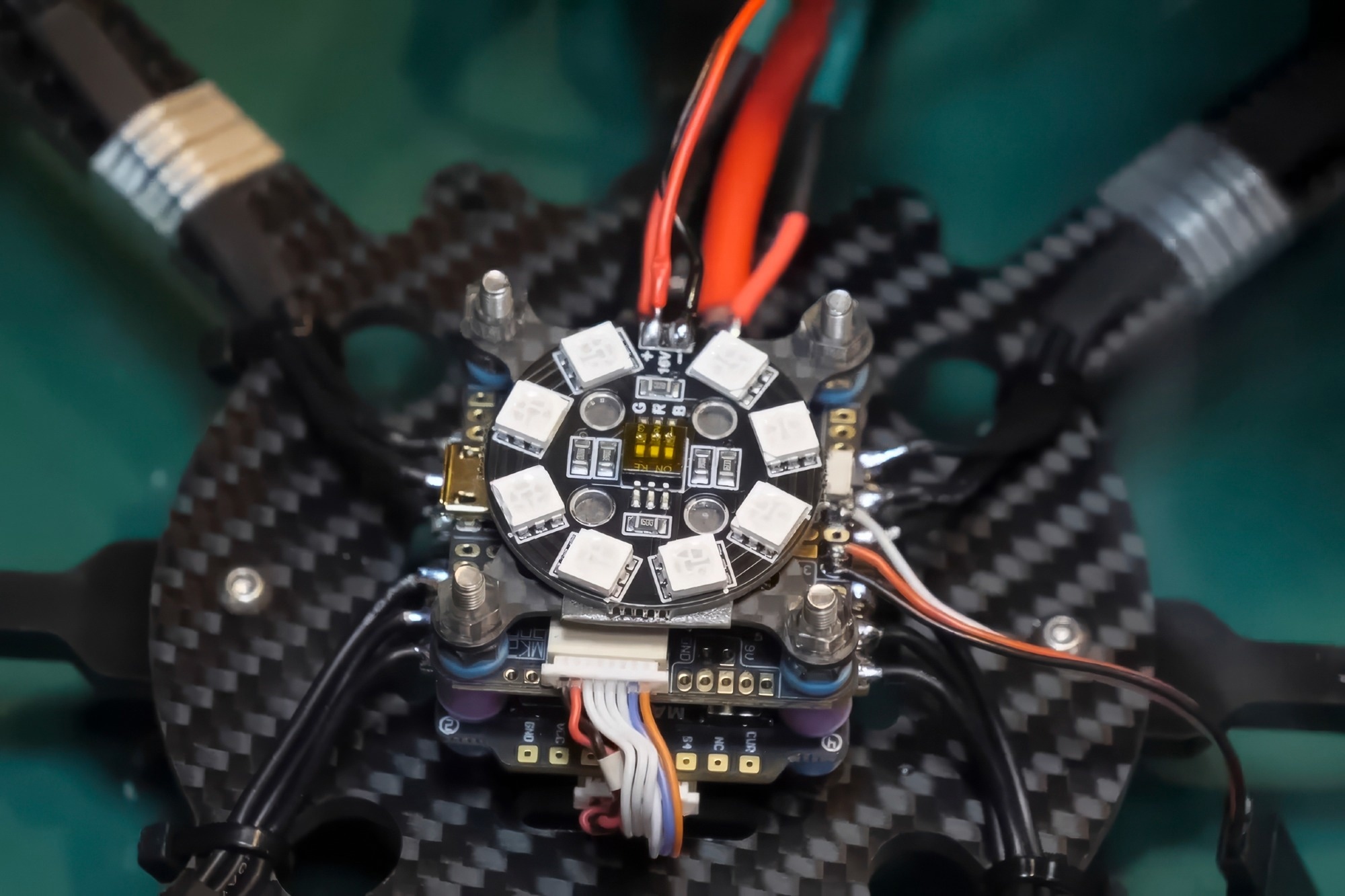 Soldering the power wires to the drone controller board.