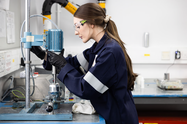 Female scientist in a lab wearing safety goggles