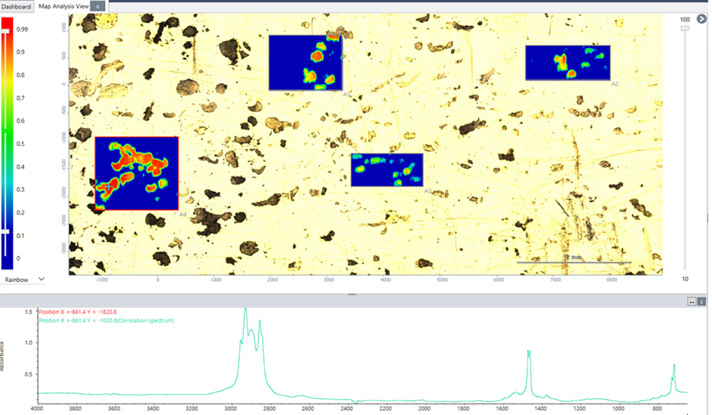 Reflective gold surface covered with microplastic particles. Four regions were selected for analysis. Regions highlighted