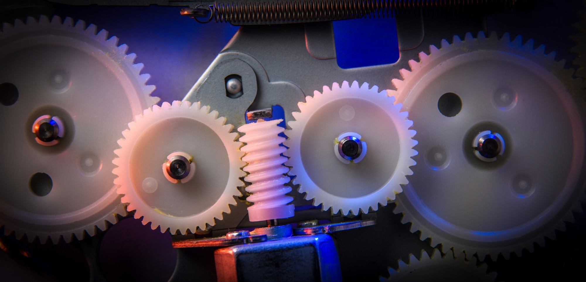Interlocking plastic and metal gears inside a mechanical system. Image Credit: Davizro Photography / Shutterstock