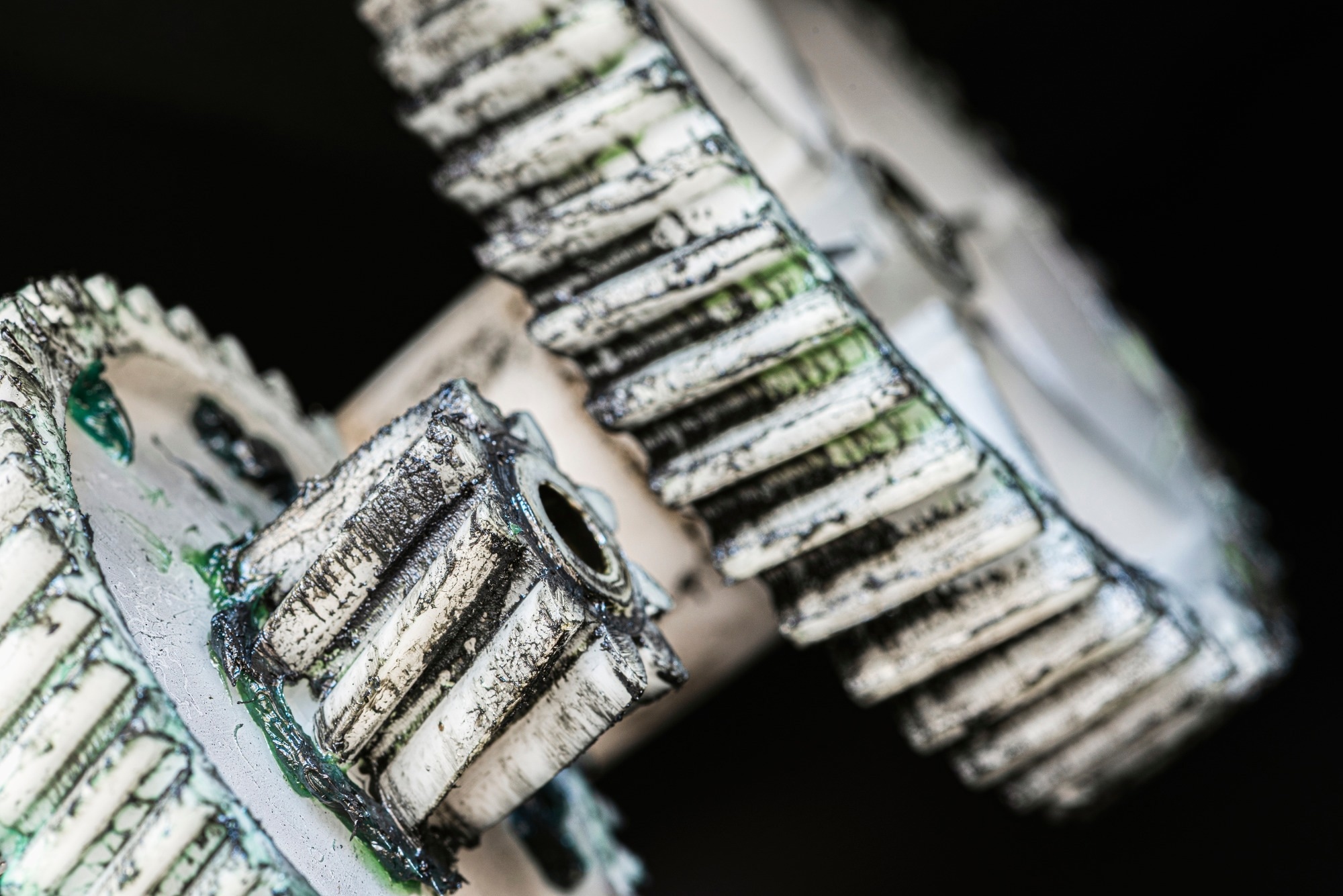 Worn plastic gears with grease, mechanical components of household appliances. Image Credit: Flegere / Shutterstock