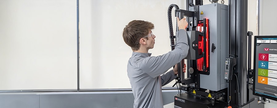 Male scientist using Instron equipment