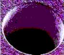 SEM of a 0.64 mm hole ultrasonically machined in an alumina substrate.