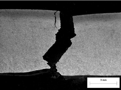 Photomicrograph of cracking initiating in a hard spot.