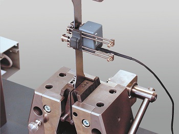 A Zwick Roell Clip-on Extensometer - Measuring Strain on a Metal Specimen.