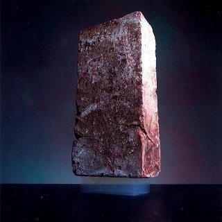 Don’t judge a book by its cover: Though incredibly light and ghost-like in appearance, this small piece of aerogel can easily support a standard house brick.