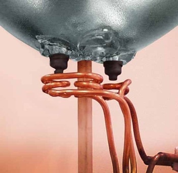 Replacing torch brazing with a multi-position helical coil to induction braze two or three nickel plated steel ferrules to nickel plated pins from an Automobile light bulb. 8kW at 360kHz for 6 seconds to 620°C (1150°F).