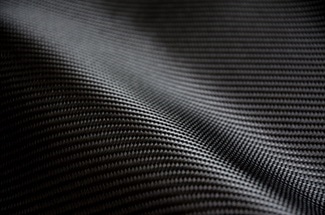 Compressed Glassy Carbon: A New and Highly Flexible and Strong Material
