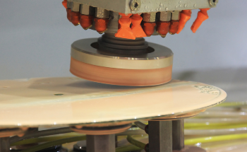 Reduction of Ceramic Machining Defects by Regulated Force Feeding Grinding System