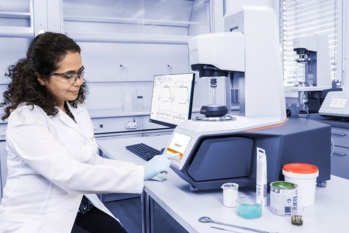 A woman in full PPE uses the equipment.