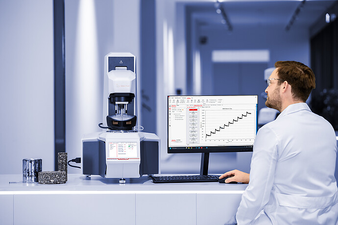A science engineer reviews a spectra on a desktop.