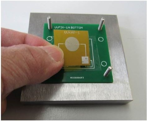 Placing new UV Cure Sensor on reusable cling film for next test