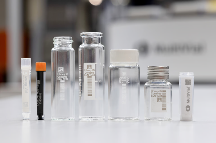 A series of vials stood next to each other of varying heights on a benchtop.