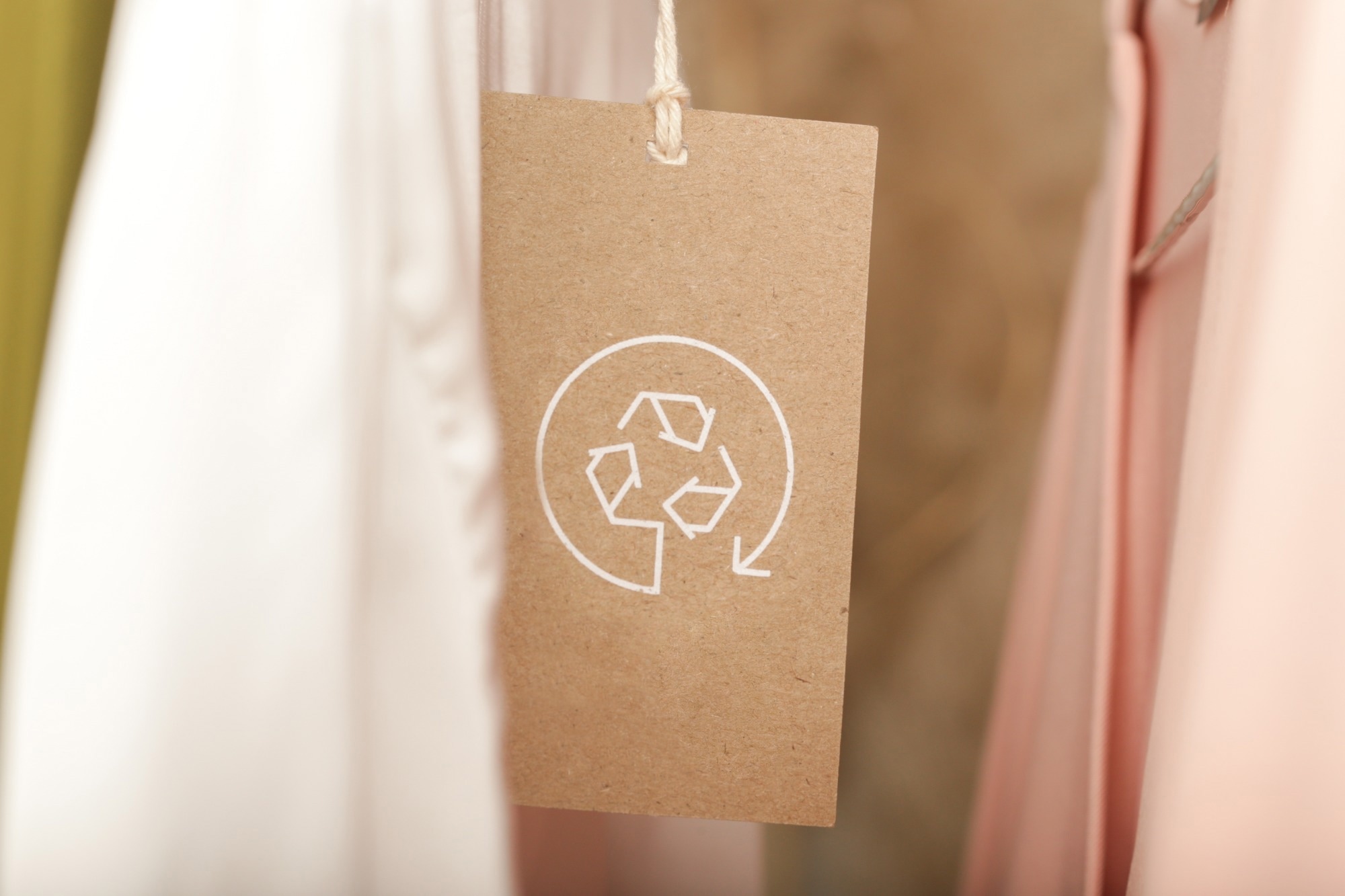 Close up of clothing tag with recycle icon