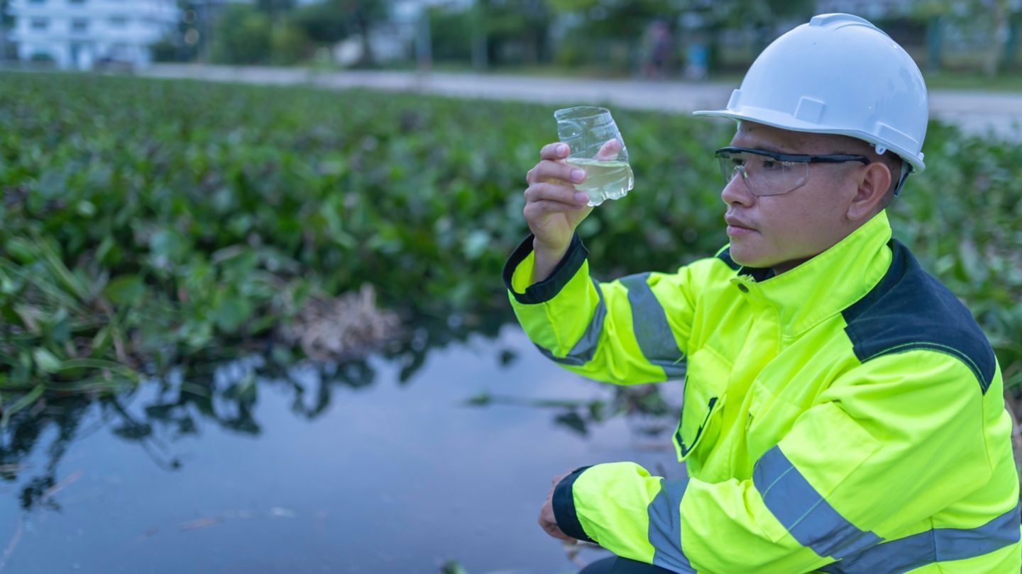 An engineer inspecting water quality.