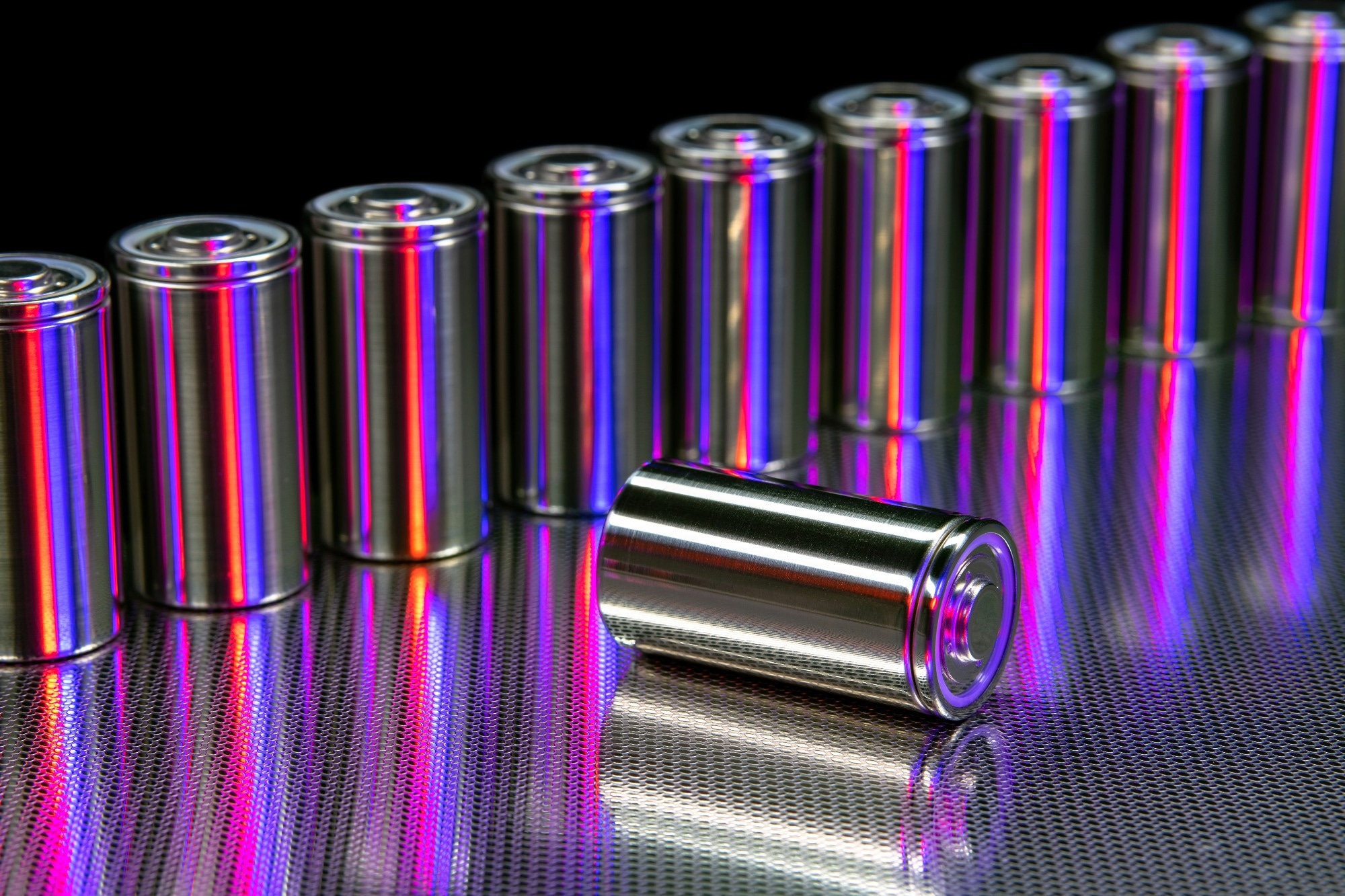 A line of batteries with one moved slightly forward and on its side.