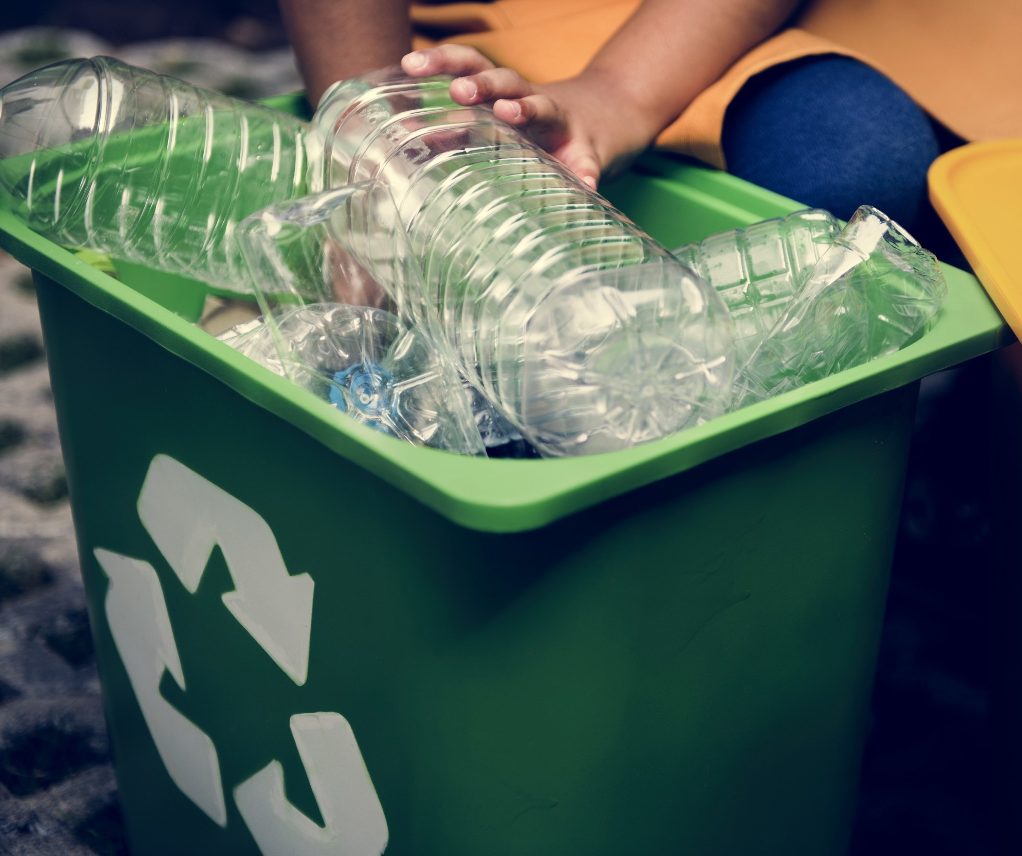 Study: Salt-templated transformation of waste plastics into single-atom catalysts for environmental and energy applications. Image credit: Rawpixel.com/Shutterstock.com Large, clear plastic bottles in a green bin with the recycling symbol on it.