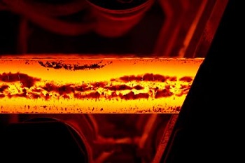 Magnons and Phonons Interact to Increase Stability of Iron at High Temperatures