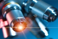 Light-Shrinking Material Turns a Conventional Light Microscope into a Super-Resolution Device