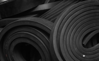 Active Lamb Wave Energy Analysis of Debonding Defects in Polymer-Rubber Structures