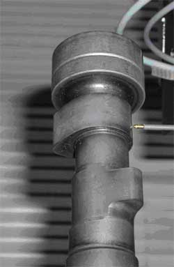 Camshaft under test to measure roundness of bearings and lobes.