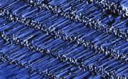 AZoM - Metals, Ceramics, Polymer and Composites : Scanning electron microscope image shows rows of horizontal zinc-oxide nanowires grown on a sapphire surface. The gold nanoparticles are visible on the ends of each row.