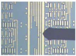 AZoM - The A to Z of Materials - AFM tip pointing toward an unknown feature on a line of a semiconductor IC